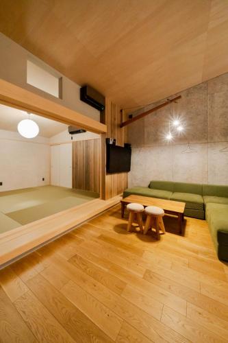 a living room with a couch and a table at TUGBOAT Suite in Osaka