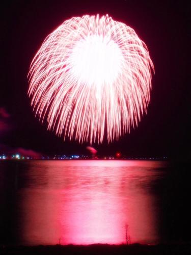 a firework display over a body of water at night at 佐渡古民家一棟貸切 Active Art Hotel 日本庭園 佐渡アート in Sado