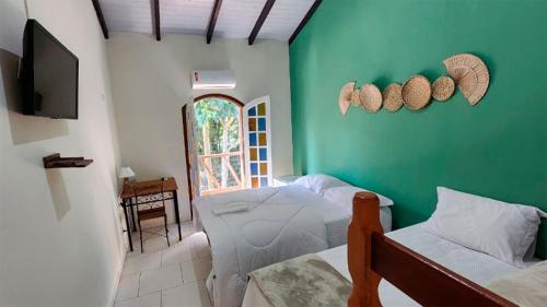 Una cama o camas en una habitación de Pousada Numar Maresias