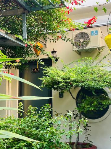 a building with a bunch of plants in front of a door at Homestay Mai Ngọc Tây Ninh in Tây Ninh
