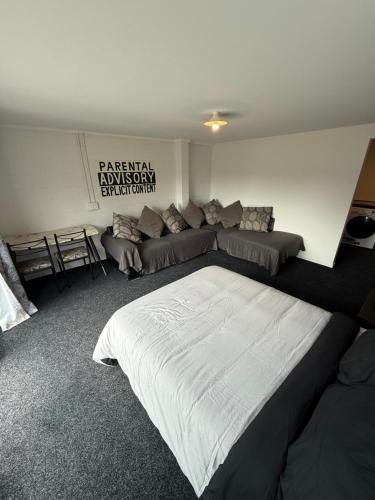 a bedroom with a large bed and a couch at Convenient Affordable Hospital Stay in Tauranga
