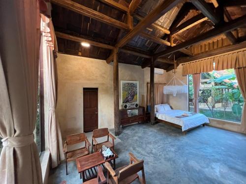 a large living room with a bed and a couch at HappyZen Farm in Vung Tau