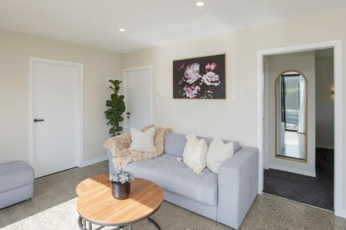 a living room with a couch and a table at Brand New Unit only 4 km to Gisborne CBD in Gisborne