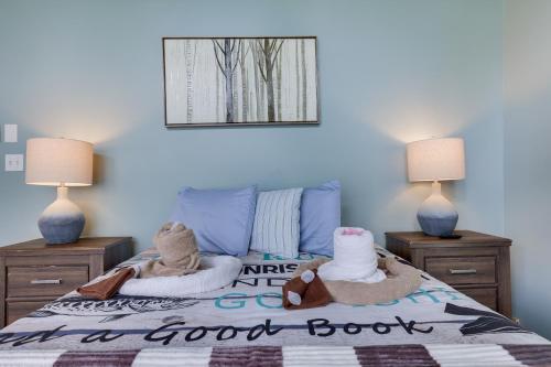 a bedroom with a bed with two towels and two lamps at Emerald Escape Lake, Theater, Game Room & More! in Long Pond