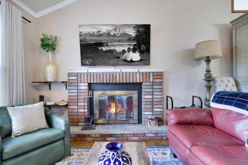a living room with a couch and a fireplace at Emerald Escape Lake, Theater, Game Room & More! in Long Pond