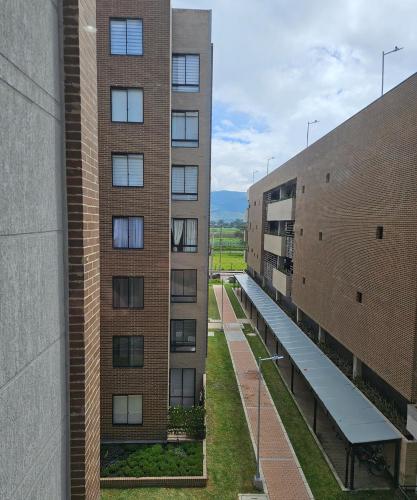 two tall brick buildings with a hallway between them at Modern Apartment In Cajica in Cajicá