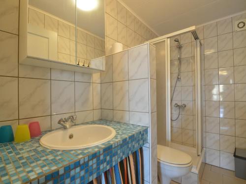 a bathroom with a sink and a shower and a toilet at Group house with 3 apartment for family in Amblève