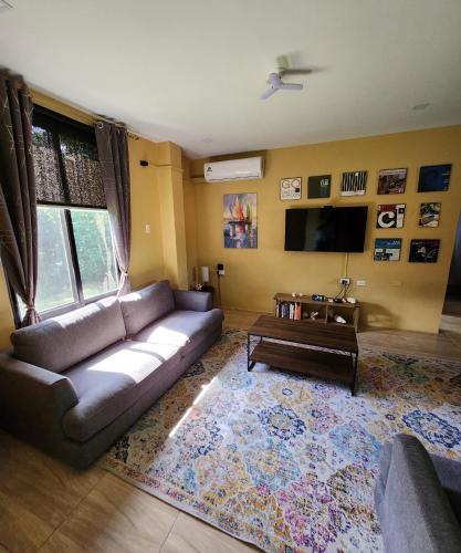 a living room with a couch and a tv at Carolina Point Resort in Crown Point