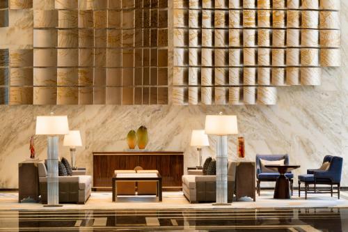 a lobby with couches and chairs and a table at Kempinski Hotel Fuzhou in Fuzhou
