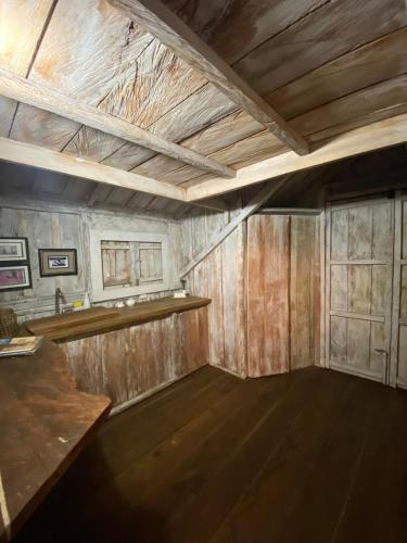 an empty room with wooden walls and a wooden table at Cabaña Peñones in Murillo