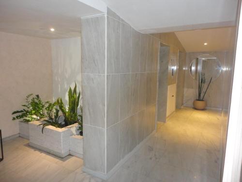 a hallway with potted plants in a building at Ipanema's heart in Rio de Janeiro
