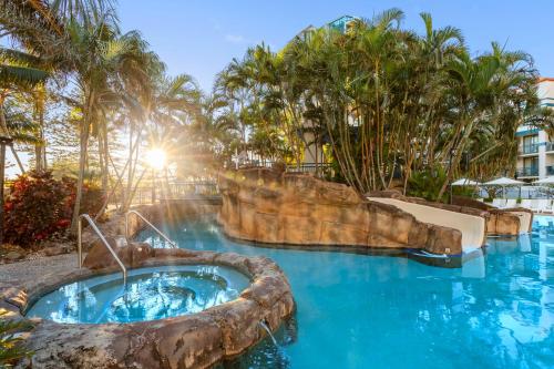 a pool at a resort with a water slide at Oaks Gold Coast Calypso Plaza Suites in Gold Coast