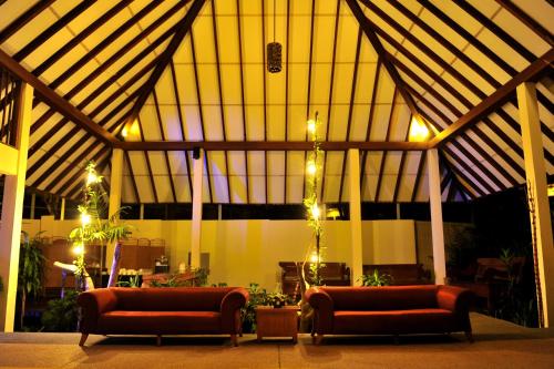 a room with two couches and lights in a building at Tanjung Rhu Resort in Tanjung Rhu 