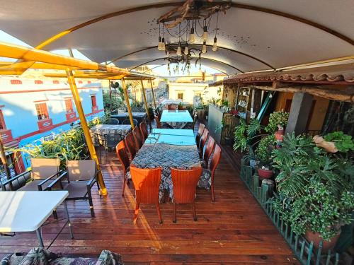 a restaurant with a table and chairs and plants at Boutique Hotel Casa Cid de León in Oaxaca City