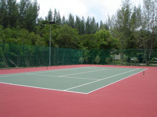 a tennis court with a fence around it at Tanjung Rhu Resort in Tanjung Rhu 