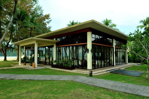 a building with a lot of windows in a park at Tanjung Rhu Resort in Tanjung Rhu 