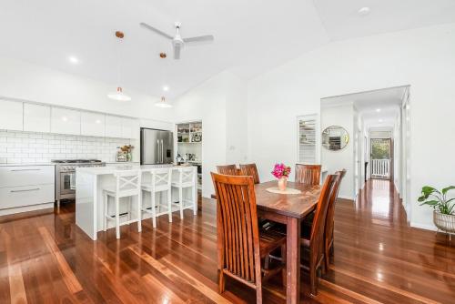 a kitchen and dining room with a table and chairs at Spacious Queenslander Retreat in Belgian Gardens