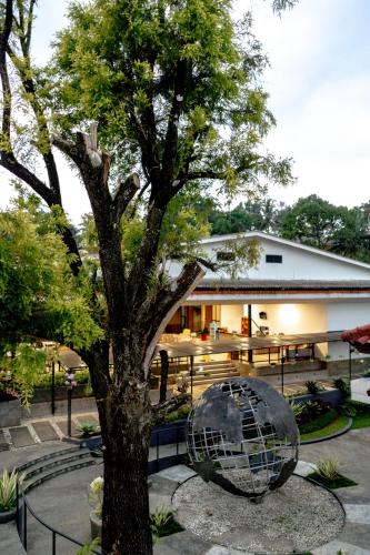 a building with a tree and a globe in front of it at HOTEL & WISMA BINTANG JADAYAT in Bogor