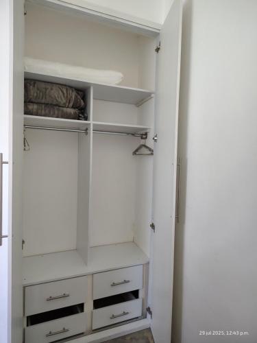 a walk in closet with white cabinets and shelves at Loft Diana - Tres Reinas Cuernavaca in Cuernavaca
