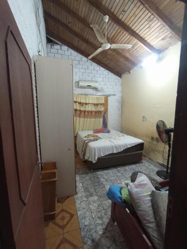 a bedroom with a bed and a ceiling fan at Casa Para World Rally Car 2025 in Encarnación