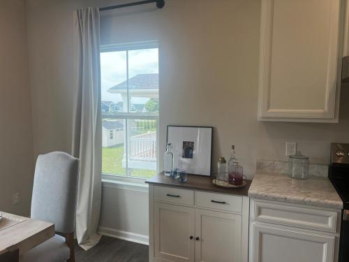 a kitchen with a counter and a window with a view at Modern Luxury Retreat by Oak Hill Park New 3BR in Wooster