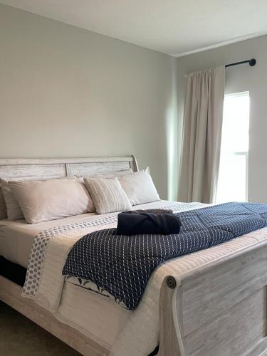 a bedroom with a large bed with pillows and a window at Modern Luxury Retreat by Oak Hill Park New 3BR in Wooster