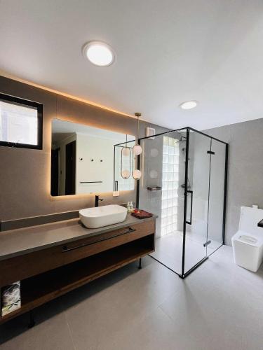 a bathroom with a sink and a toilet and a mirror at Mana Island Resort & Spa - Fiji in Mana Island