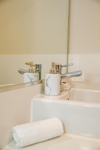 a bathroom with two faucets and a sink at 39C Cypress in Mulwala