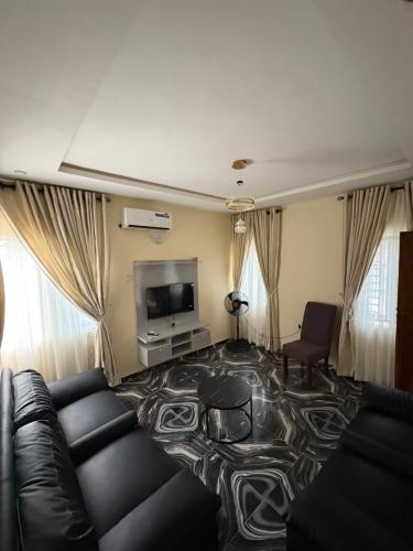 a living room with a couch and a tv at Bollington Adex house 