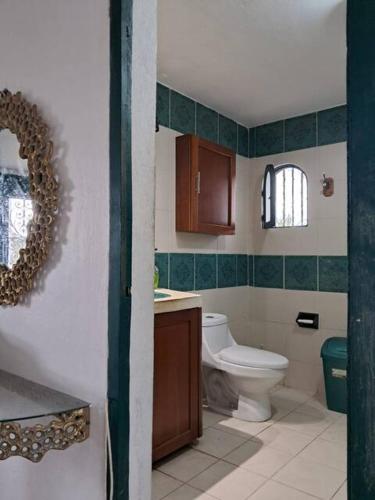a bathroom with a toilet and a sink at Driftwood Retreat in Progreso