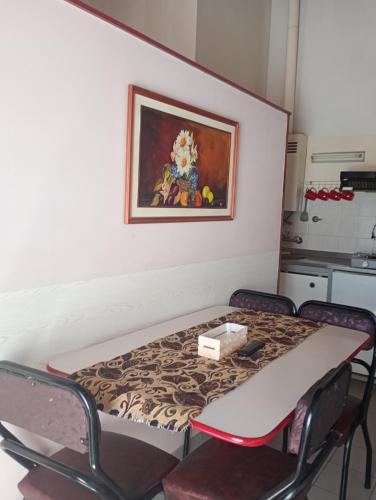 a table in a kitchen with a painting on the wall at Alojartur in San Rafael
