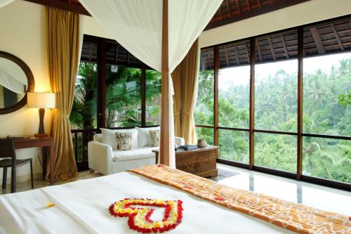 a bedroom with a bed with a number on it at Komaneka at Bisma Ubud in Ubud