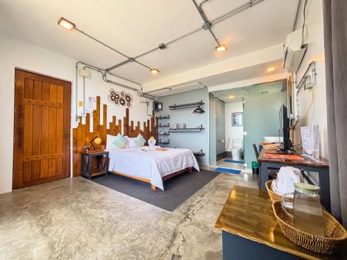a bedroom with a bed and a tv in it at AV Suites in Puerto Galera