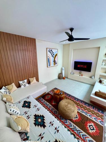 a living room with a couch and a tv at Casa Deva in Uluwatu