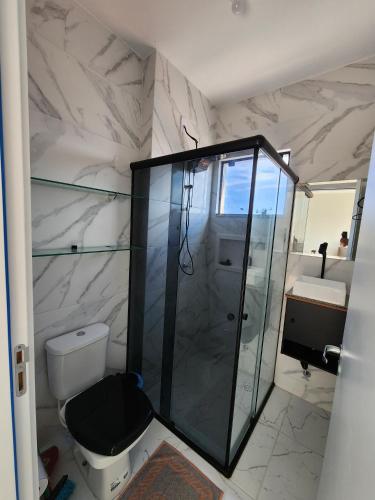 a bathroom with a shower and a toilet and a sink at apartamento in Tijucas