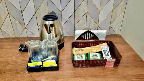 a table with a coffeemaker and a coffee pot at Urban Nest in Salem