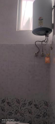 a bathroom with a window and a toilet in a room at Sanwariya Guest House in Khātu