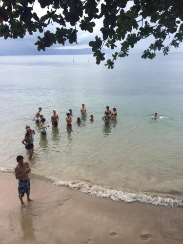 a group of people in the water at the beach at Rainbow Bungalow Haadrin Koh Phangan in Haad Rin