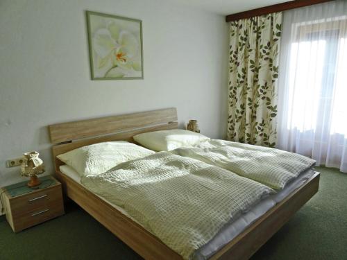 a bedroom with a bed and a window at Apartment with balcony in Hart im Zillertaler in Fügen