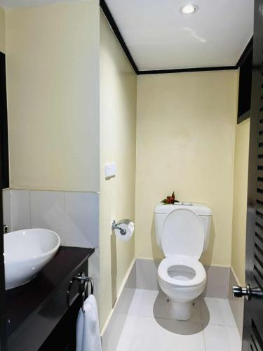 a bathroom with a white toilet and a sink at Mana Island Resort & Spa - Fiji in Mana Island