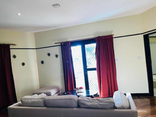 a living room with a couch and a large window at Mana Island Resort & Spa - Fiji in Mana Island