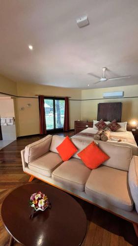 a living room with a couch and a bed at Mana Island Resort & Spa - Fiji in Mana Island