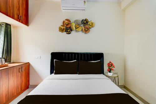 a bedroom with a bed with a black head board at Super Hotel O Shamshabad Airport Complex Formerly Urban Sleep in Shamshabad