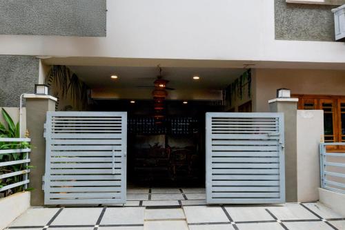 two metal doors in front of a building at Super Hotel O Shamshabad Airport Complex Formerly Urban Sleep in Shamshabad