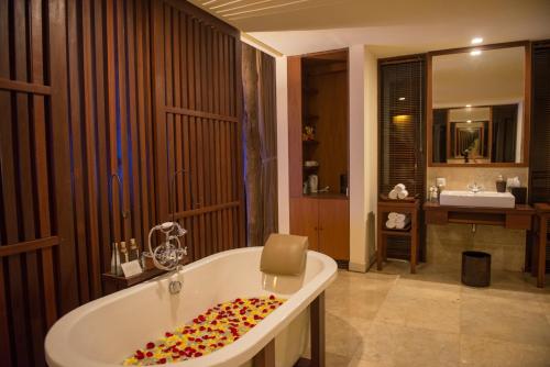 a bathroom with a bath tub and a sink at Komaneka at Bisma Ubud in Ubud