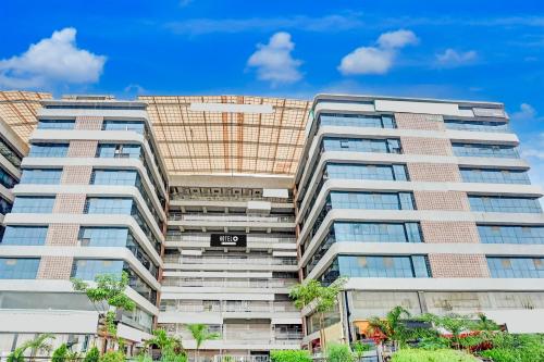 a tall apartment building with a sign on it at Super Hotel O Naroda GIDC Formerly Yuvraj in Ahmedabad