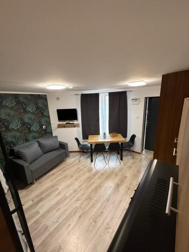 a living room with a couch and a table at Hotel pracowniczy Ostroróg in Ostroróg