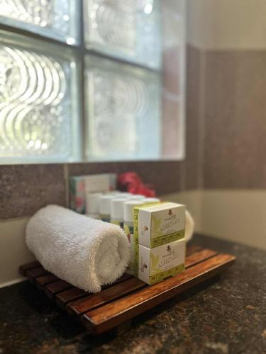 a shelf with towels and boxes on a bathroom counter at Mana Island Resort & Spa - Fiji in Mana Island