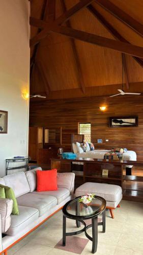 a living room with a couch and a table at Mana Island Resort & Spa - Fiji in Mana Island