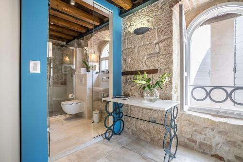 a bathroom with a sink and a toilet in a room at Bella Notte Di Spalato in Split